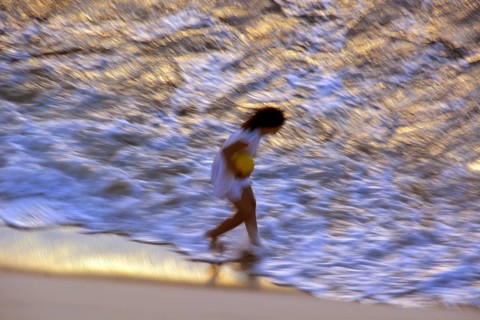 Woman on the beach in the evening