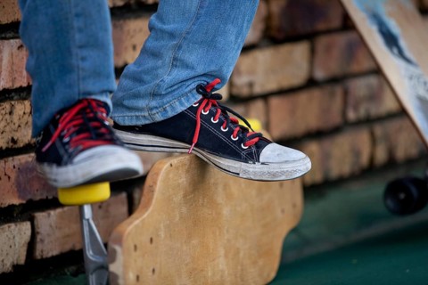 Teenager's feet on longboard