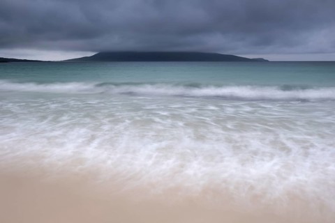 Mount Ceapabhal veiled by dark rain clouds on the horizon