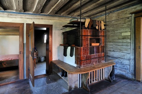 Living room with a tiled stove in a farmhouse