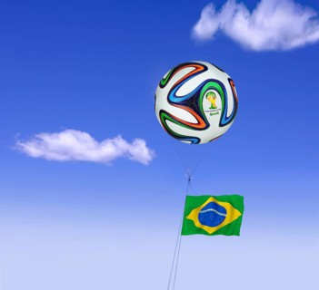 World Cup football as a tethered balloon against a blue sky with the flag of Brazil flying