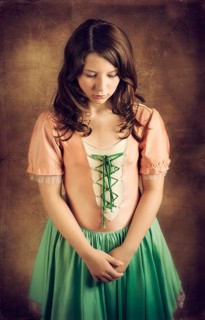 Girl wearing an old-fashioned dress looking sad