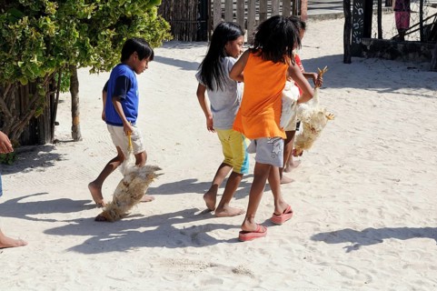Kuna Indian children carrying chickens