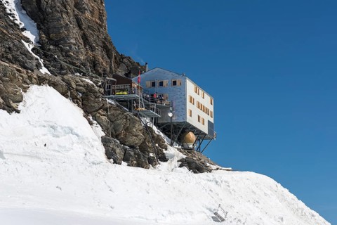 Monchsjoch Hut on a rock wall