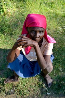 Old woman sitting in the grass