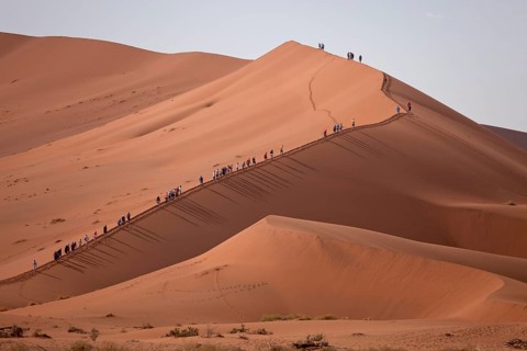 Tourists climbing the Sossusvlei Dunes