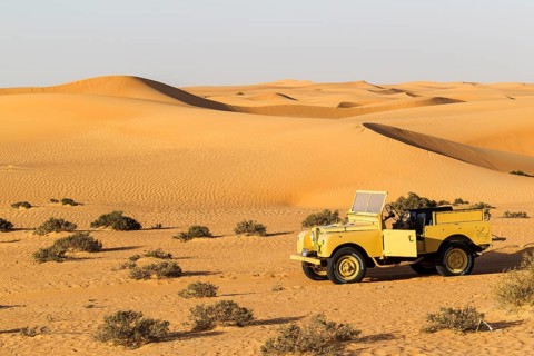 Land rover from the 50s before sand dunes