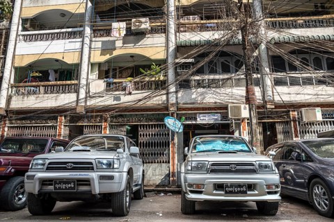 Vehicles parked in front of a residential building