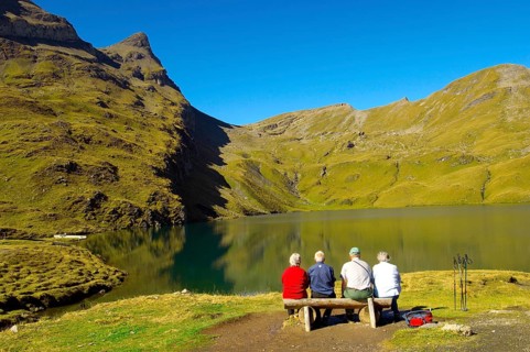 Walkers having a rest next to Bachalpsee lake near Grindelwald First