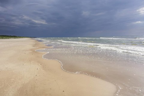 Sandy beach on the Baltic sea with storm clouds