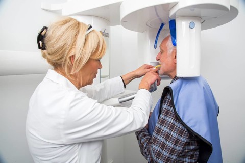 Man being prepared for an X-ray of his teeth