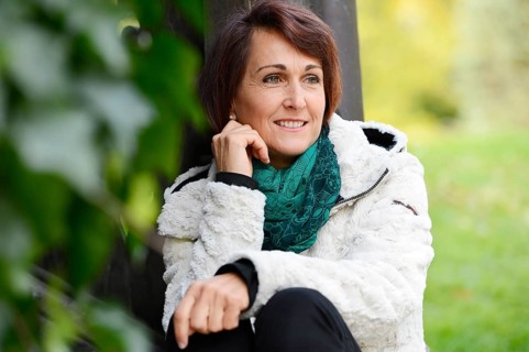 Smiling woman sitting outdoors