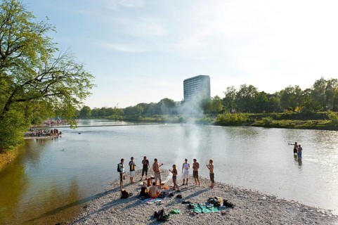 Young people having party on the Isar River in summer