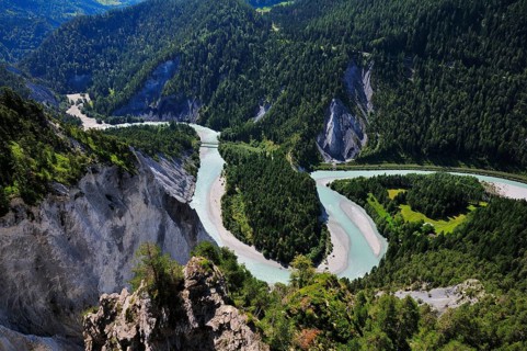 River bend of the Vorderrhein with railway bridge of the Rhaetian Railway