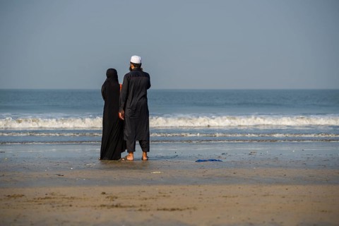 A Muslim couple is standing at Juhu Beach