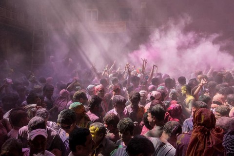 Devotees celebrating and throwing coloured powder