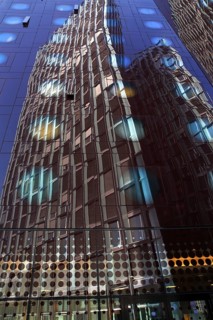 Tanzende Turme office building reflected in the facade of the Arcotel Onyx Hotel