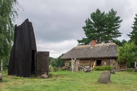 House in an old fishing village and part of a wooden boat that serves as a smokehouse