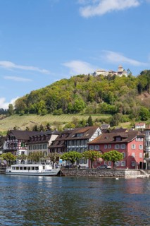 Townscape on the bank of the Rhine River with a boat landing and Burg Hohenklingen Castle