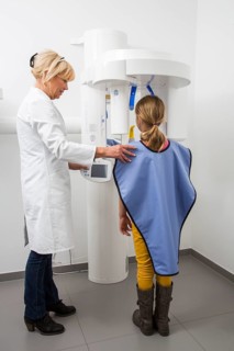 Girl being prepared for an x-ray of her teeth