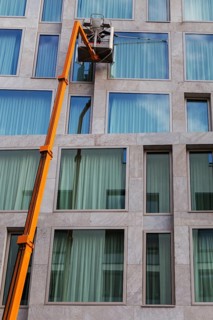 Window cleaner cleaning the windows of a hotel