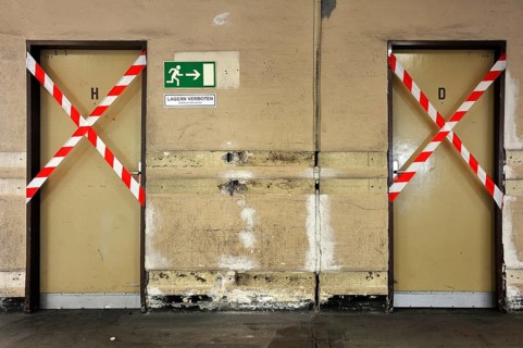 Blocked ladies and gents toilets in the empty shipping hall of a former department store