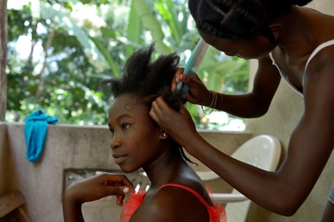 Young women braiding their hair