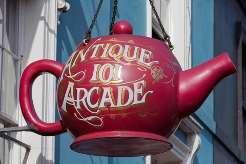 Large tea pot on the facade of an antiques shop