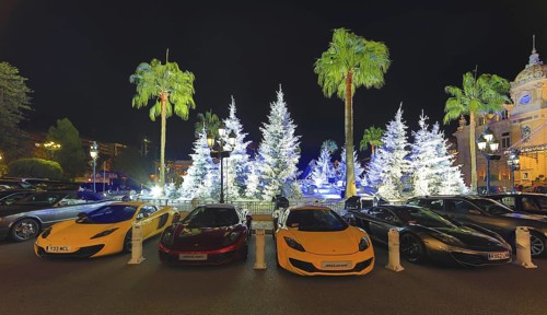 Four McLaren sports car in front of Christmas decoration with white fir trees on the square in front of the Casino de Monte-Carlo