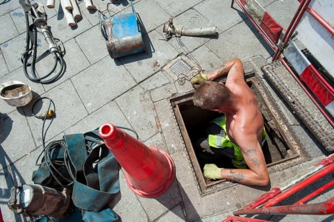 Telephone engineer replacing old copper cables with fibreglass lines