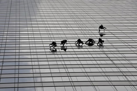Window cleaners cleaning a glass facade