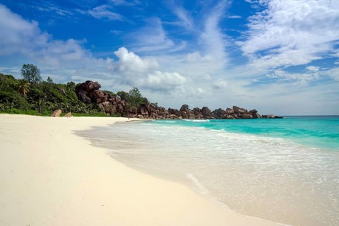 Sandy beach with the rock formations typical for the Seychelles