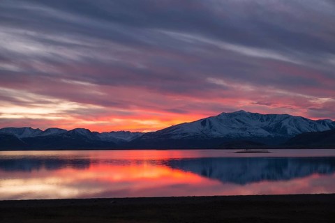 Sunset with an intense coloured sky reflected in Khoton Nuur