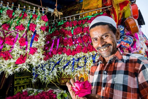 A Muslim salesman is selling flowers