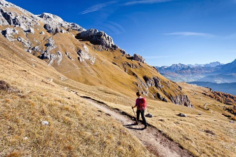 Mountain climber on the Dolomiten-Hohenweg mountain trail while ascending Peitlerkofel Mountain in Puez-Geisler Nature Park