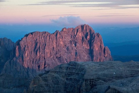View from Pordoi Pass of mountains Sellastock and Langkofel or Sasso Lungo at dusk