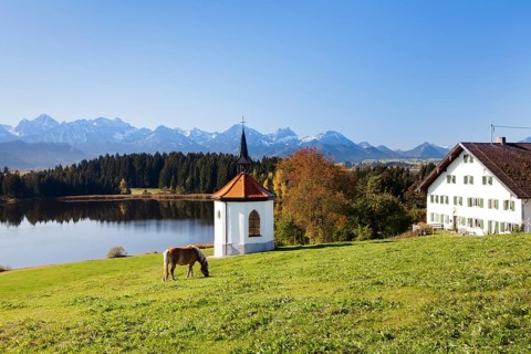 Chapel on Lake Hergratsried with Allgau Alps