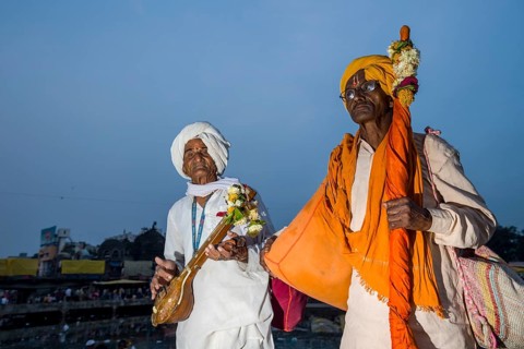 Two devotees with their music instruments at the banks of the holy river Godwari