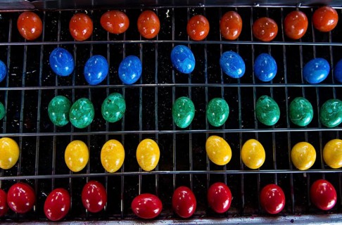 Brightly coloured Easter eggs on a conveyor belt