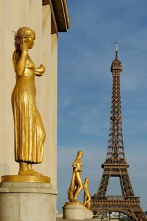 Golden statues at the Palais de Chaillot with the Eiffel Tower