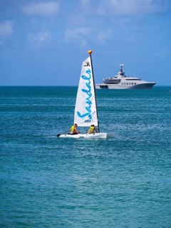 Catamaran and a motor yacht in Rodney Bay