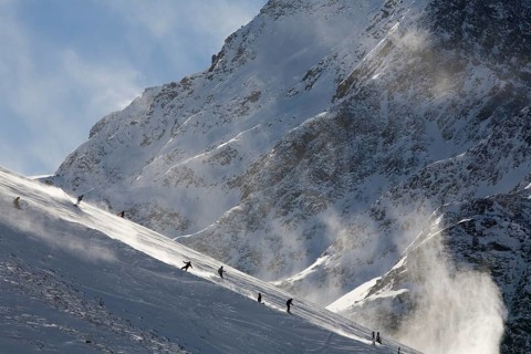 Skiers going downhill