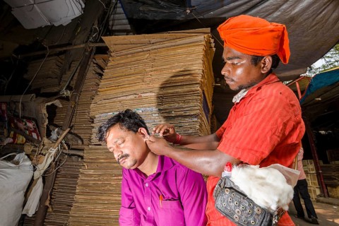 An ear cleaner at work at Mangaldas Market