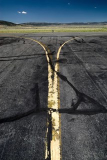 Yellow worn tarmac markings at an airport