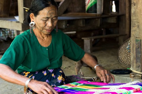 Woman with traditional facial tattoos and ear jewellery from the Chin people