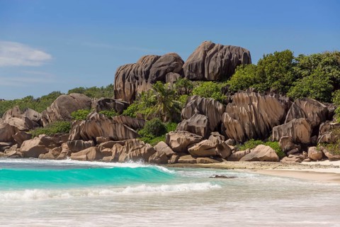 Sandy beach with the rock formations typical for the Seychelles