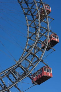 Three cabins of the Wiener Riesenrad ferris wheel against a blue sky at the Prater