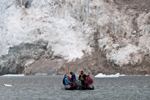Tourists and guides in an inflatable boat