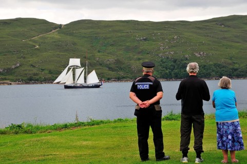 People on the shore looking at the Dutch two-masted Topschoner Wylde Swan on Loch Broom