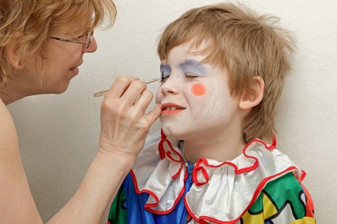 Little boy dressed as a clown